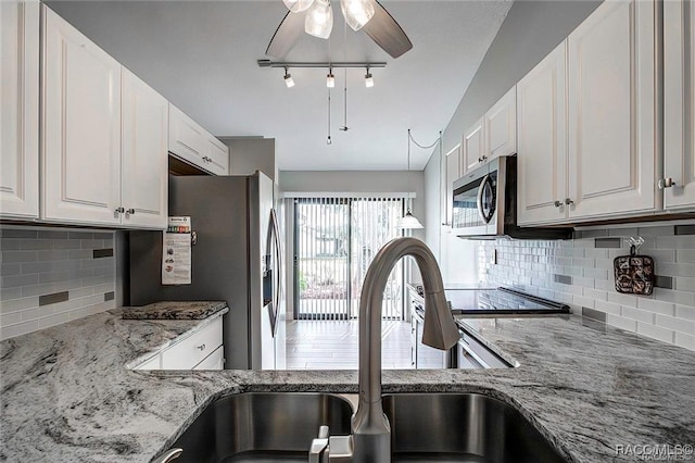 1309 Longboat Pt, Inverness, FL 34450 - kitchen with a sink, backsplash, light stone counters, and stainless steel appliances