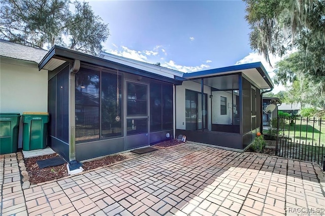 1309 Longboat Pt, Inverness, FL 34450 - back of house featuring a sunroom and stucco siding