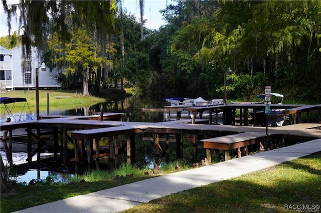 1309 Longboat Pt, Inverness, FL 34450 - dock area featuring a water view, boat lift, and a lawn