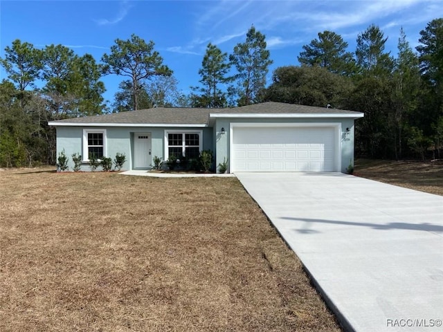 single story home featuring a garage and a front yard