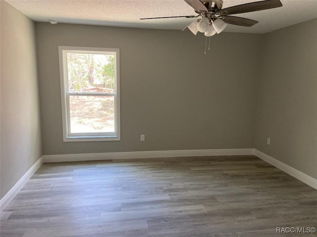 unfurnished room featuring hardwood / wood-style floors, a textured ceiling, and ceiling fan