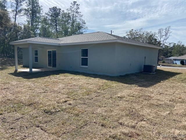 back of property featuring a patio area, a lawn, and central air condition unit