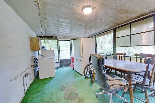 unfurnished sunroom with washer / clothes dryer and track lighting