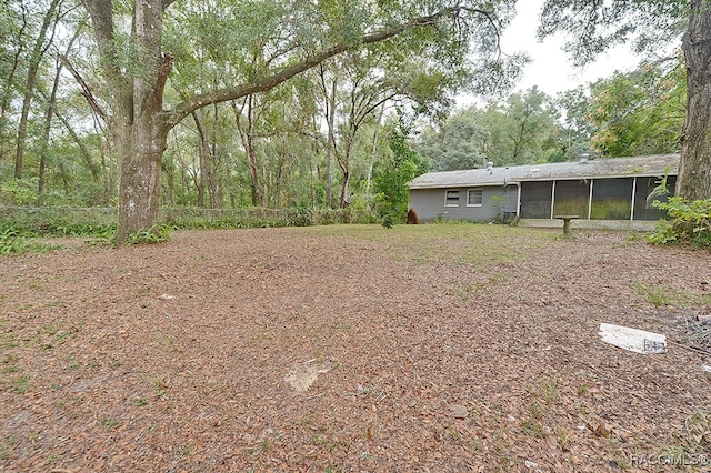 view of yard with a sunroom