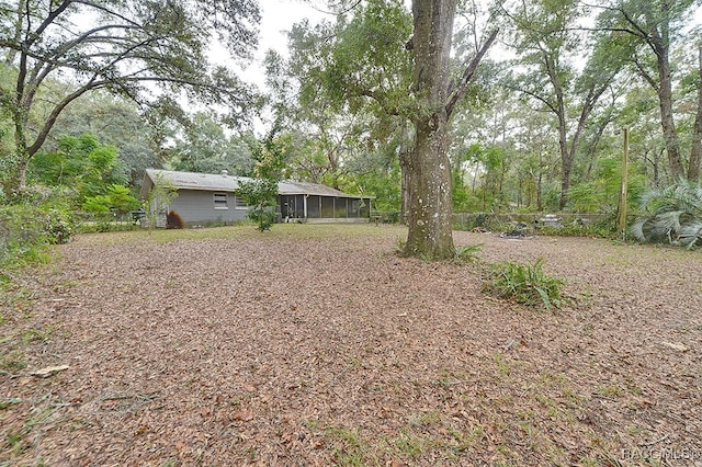 view of yard featuring a sunroom