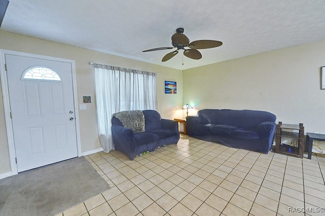 tiled living room featuring a textured ceiling and ceiling fan