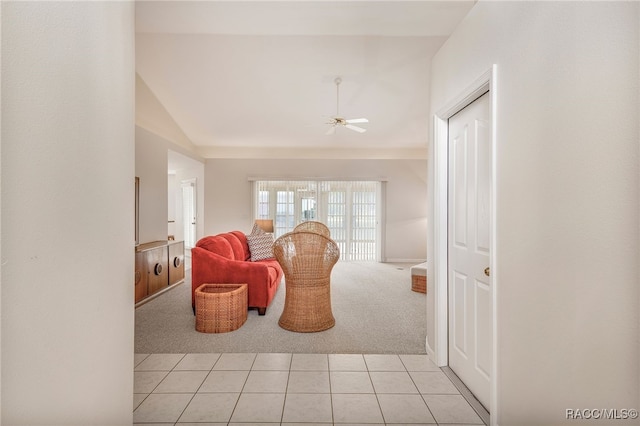 sitting room featuring light tile patterned floors, light carpet, vaulted ceiling, and ceiling fan