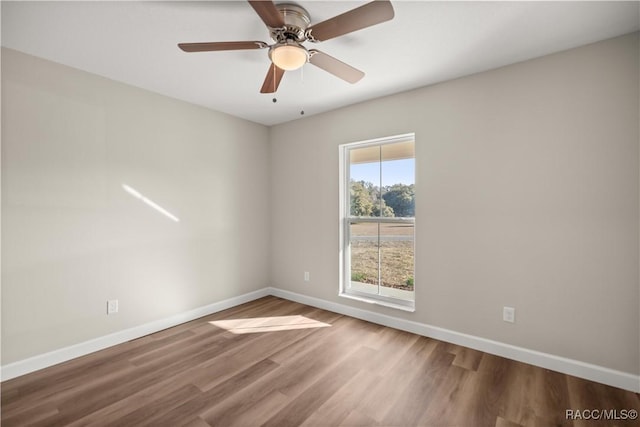 empty room featuring ceiling fan and hardwood / wood-style floors