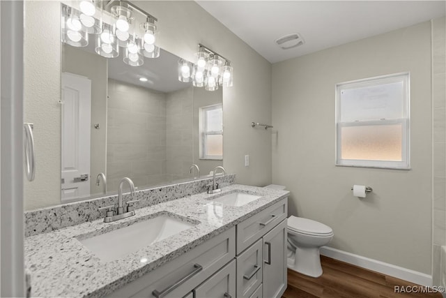 bathroom with vanity, toilet, and hardwood / wood-style floors