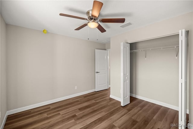 unfurnished bedroom with dark hardwood / wood-style floors, a closet, and ceiling fan