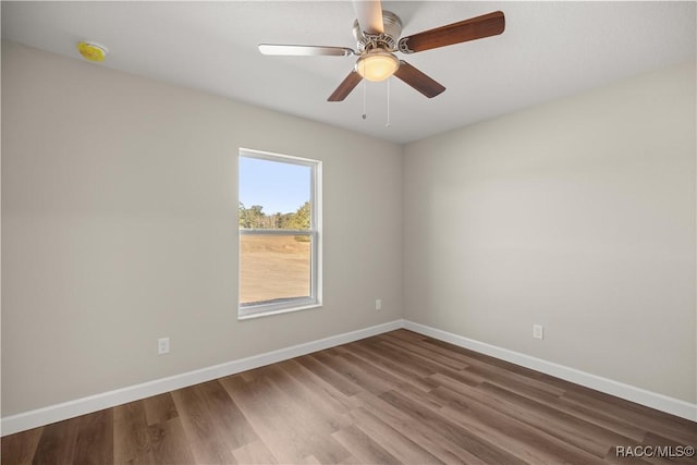 empty room featuring hardwood / wood-style floors and ceiling fan