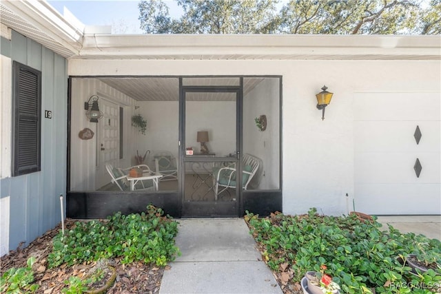 entrance to property featuring an attached garage