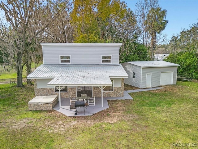 rear view of house featuring metal roof, a patio, fence, stone siding, and a yard