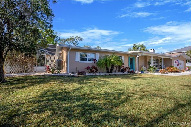 2160 N Watersedge Dr, Crystal River, FL 34429 - single story home with a front lawn, a chimney, and stucco siding