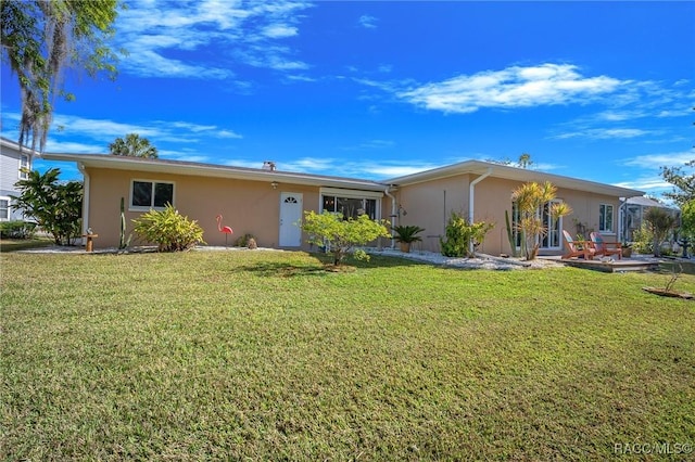 ranch-style home with stucco siding and a front yard