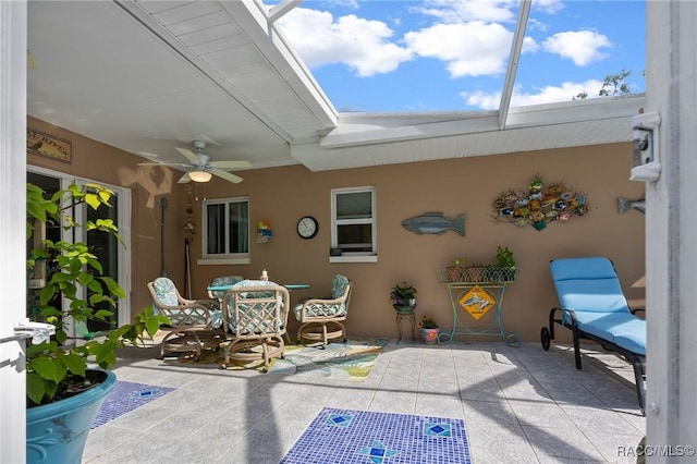 view of patio featuring a ceiling fan and a lanai