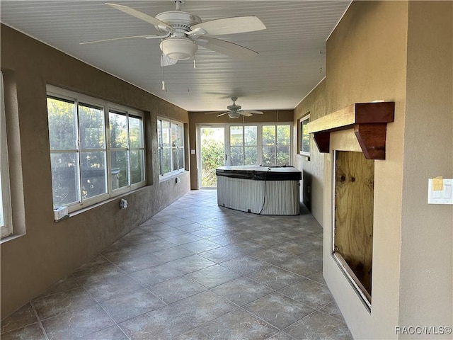 1203 SE Kings Bay Dr, Crystal River, FL 34429 - unfurnished sunroom featuring stone finish floor and a jacuzzi