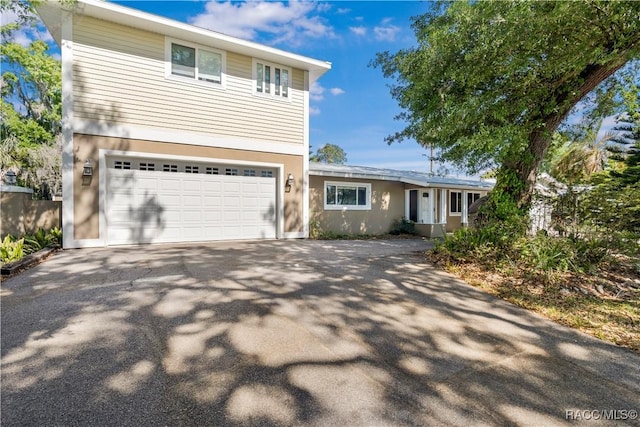 1203 SE Kings Bay Dr, Crystal River, FL 34429 - traditional-style house featuring stucco siding, an attached garage, and driveway