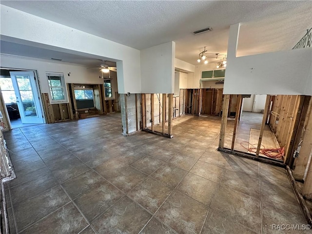 1203 SE Kings Bay Dr, Crystal River, FL 34429 - unfurnished living room with a textured ceiling, a ceiling fan, and visible vents