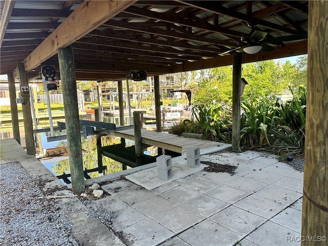 1203 SE Kings Bay Dr, Crystal River, FL 34429 - view of patio featuring a ceiling fan, a boat dock, and boat lift