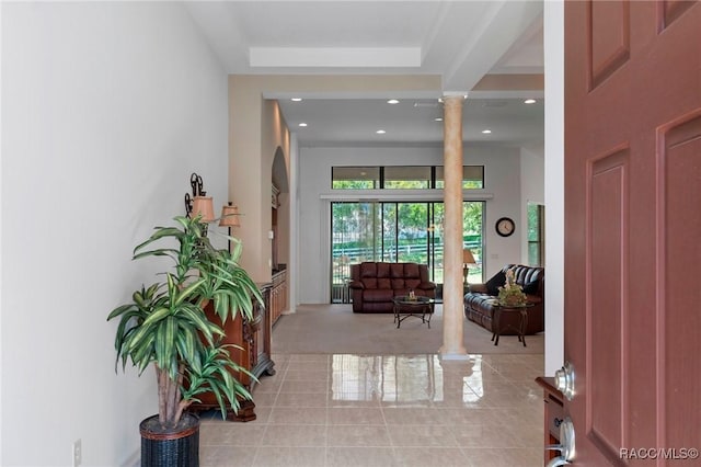 foyer entrance featuring recessed lighting, ornate columns, and light tile patterned floors