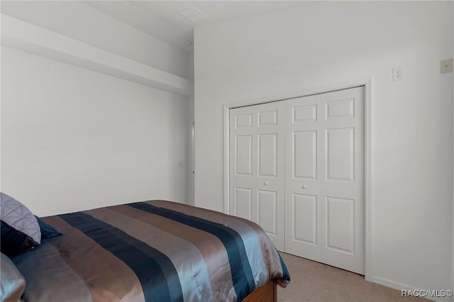 carpeted bedroom with a closet