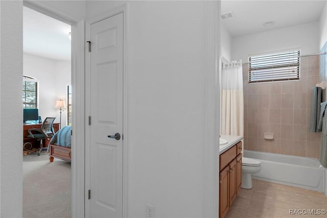 ensuite bathroom featuring visible vents, toilet, tile patterned floors, shower / bathtub combination with curtain, and vanity