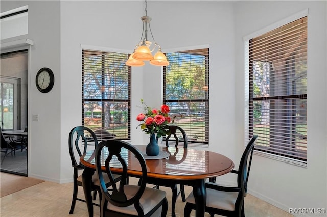 dining space featuring a healthy amount of sunlight and baseboards