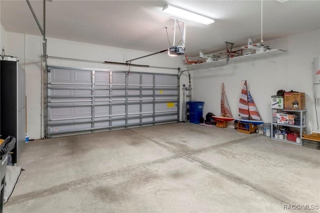 garage with freestanding refrigerator and a garage door opener