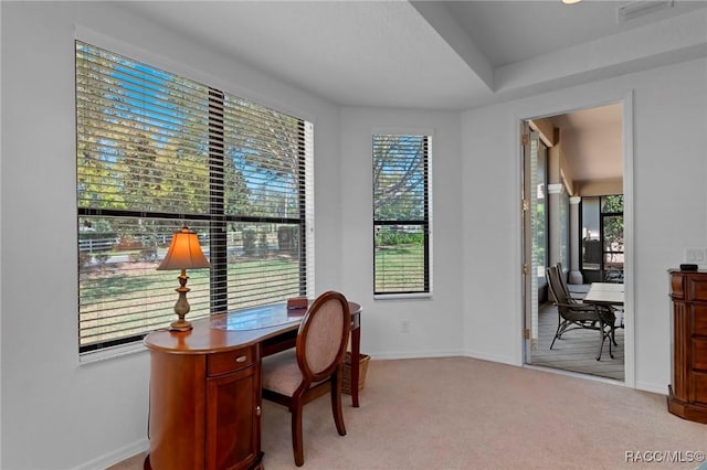 office featuring baseboards, visible vents, and light colored carpet