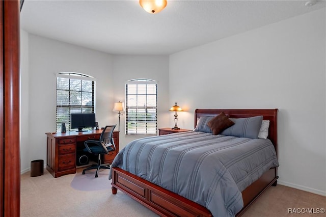 bedroom featuring carpet and baseboards