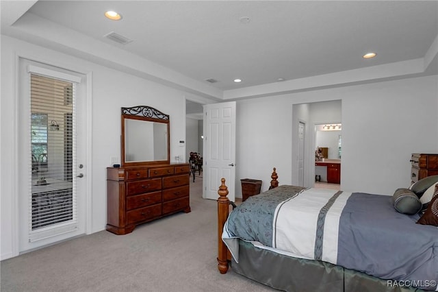 bedroom featuring a tray ceiling, light colored carpet, visible vents, and recessed lighting