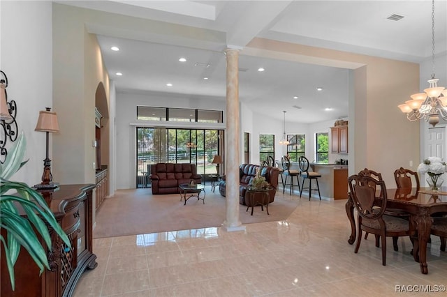 living room with ornate columns, visible vents, a chandelier, and recessed lighting