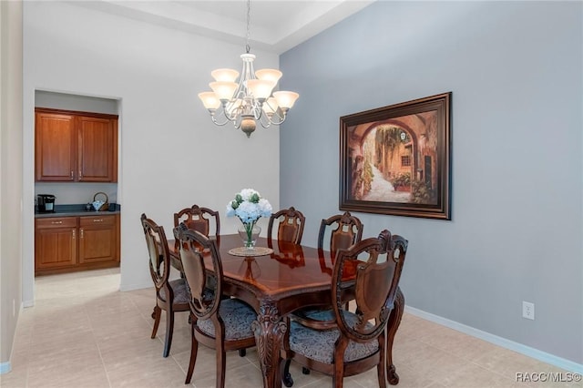 dining space featuring an inviting chandelier and baseboards