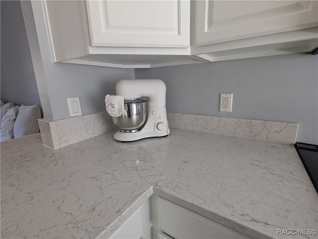 interior details with light stone counters and white cabinets