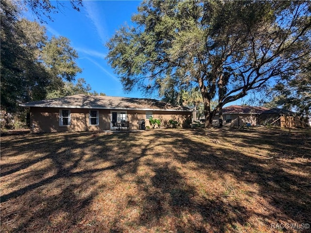 back of house with a lawn