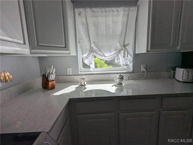 kitchen featuring sink and light stone counters