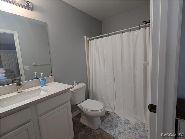 bathroom with a shower with curtain, tile patterned floors, vanity, and toilet