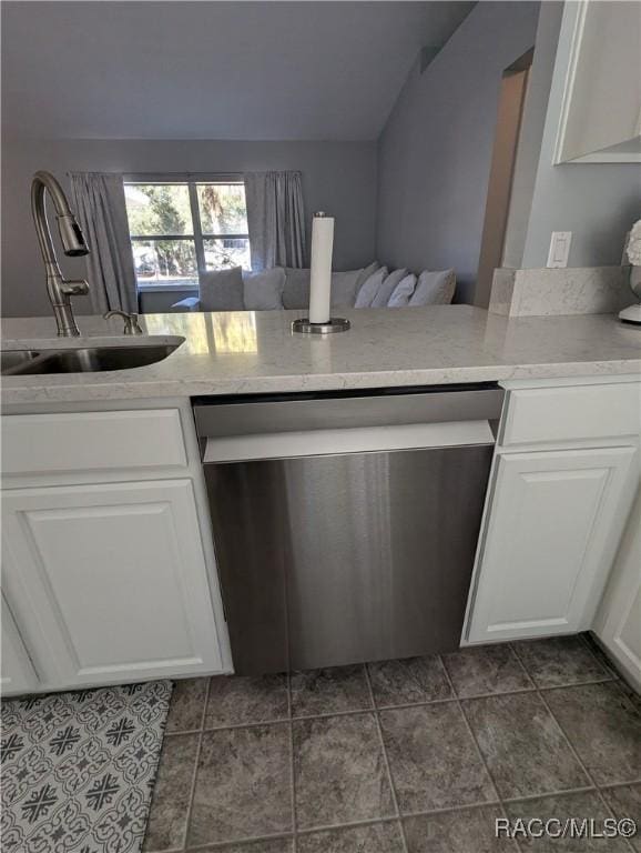 kitchen with white cabinetry, dishwasher, lofted ceiling, and sink