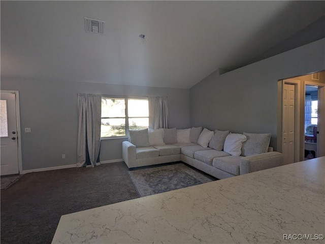 carpeted living room with vaulted ceiling