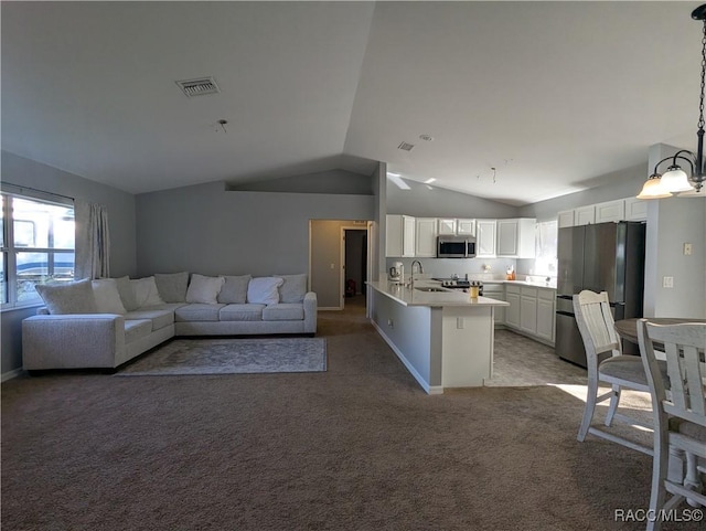 carpeted living room with lofted ceiling and sink