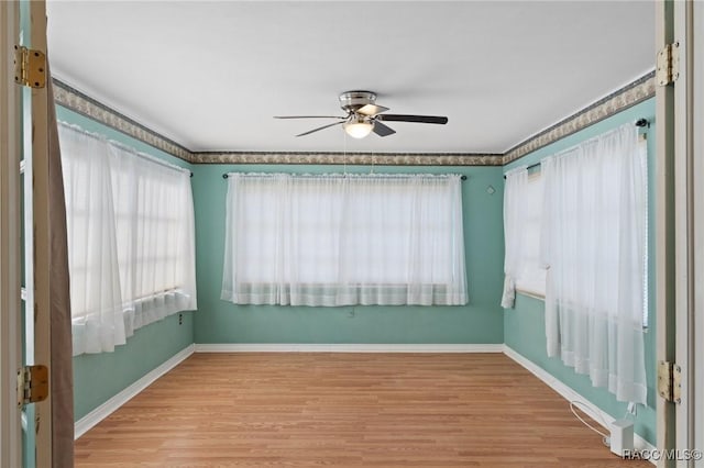 spare room featuring ceiling fan and light hardwood / wood-style flooring