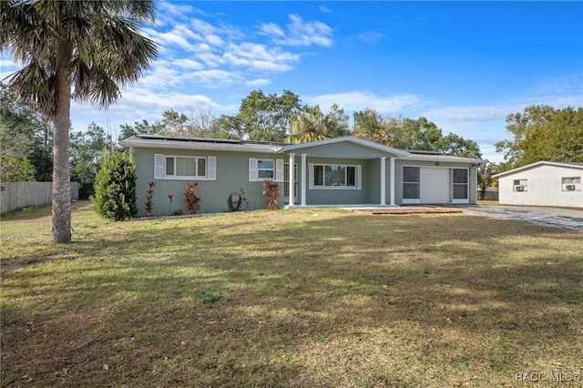 single story home with a garage and a front lawn