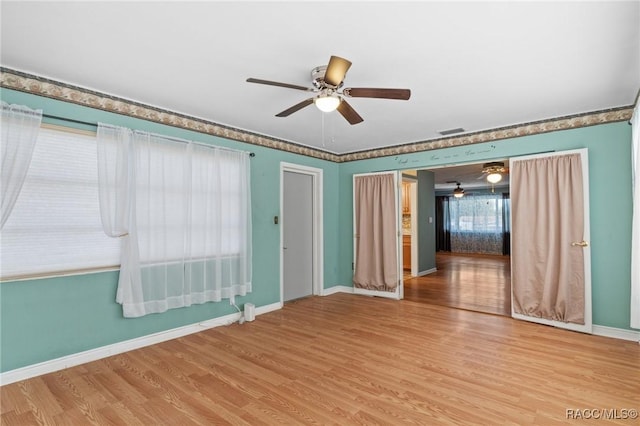 spare room with hardwood / wood-style flooring and ceiling fan