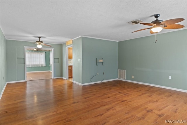 unfurnished living room featuring hardwood / wood-style flooring, crown molding, and a textured ceiling