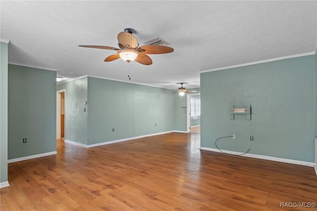 spare room with hardwood / wood-style flooring, ceiling fan, crown molding, and a textured ceiling