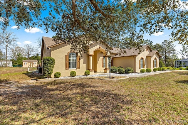 mediterranean / spanish home with a front yard and stucco siding