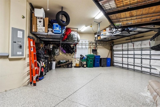 garage featuring electric panel and a garage door opener