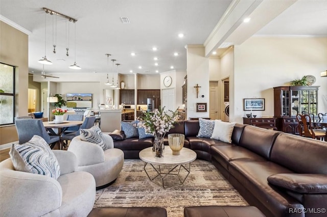 living area with ornamental molding, recessed lighting, washer / clothes dryer, and visible vents