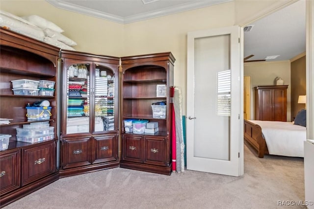 interior space featuring light carpet, visible vents, and crown molding